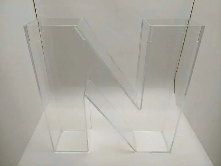 Fabricated clear acrylic three-dimensional letter N with bonded, polished edges