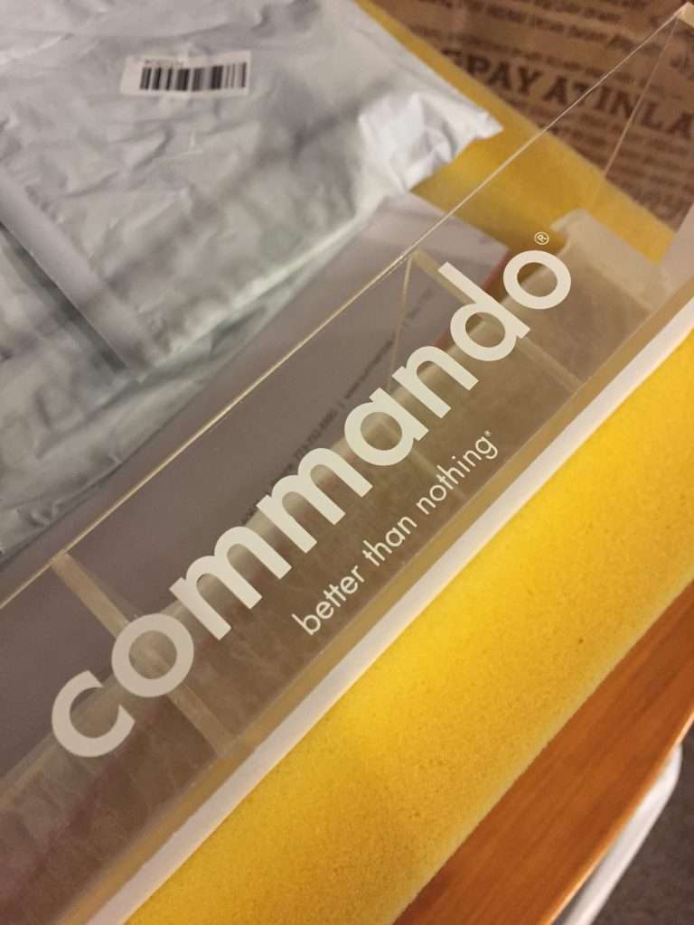 Clear acrylic display with a custom UV-printed brand logo.