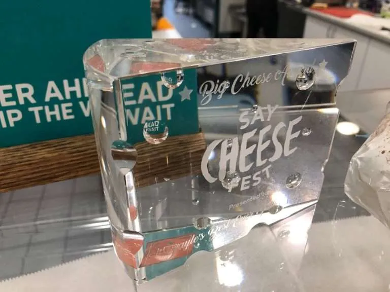 Thick clear acrylic award block with engraved event graphics.