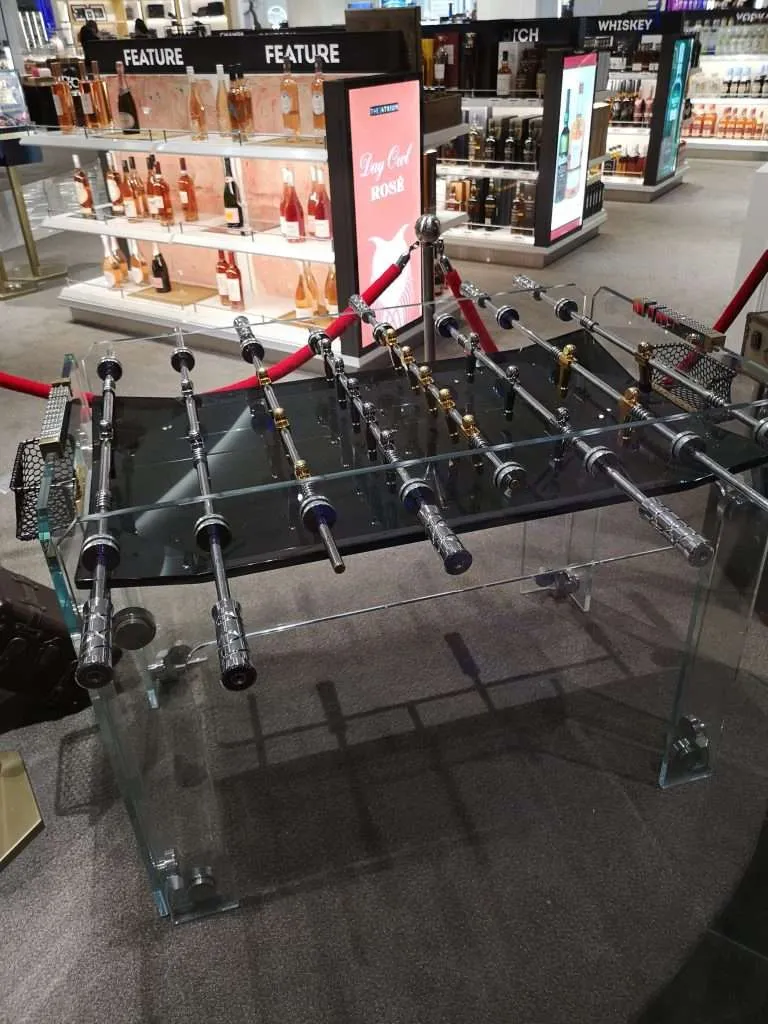 Custom clear acrylic foosball table installed in an upscale retail store.