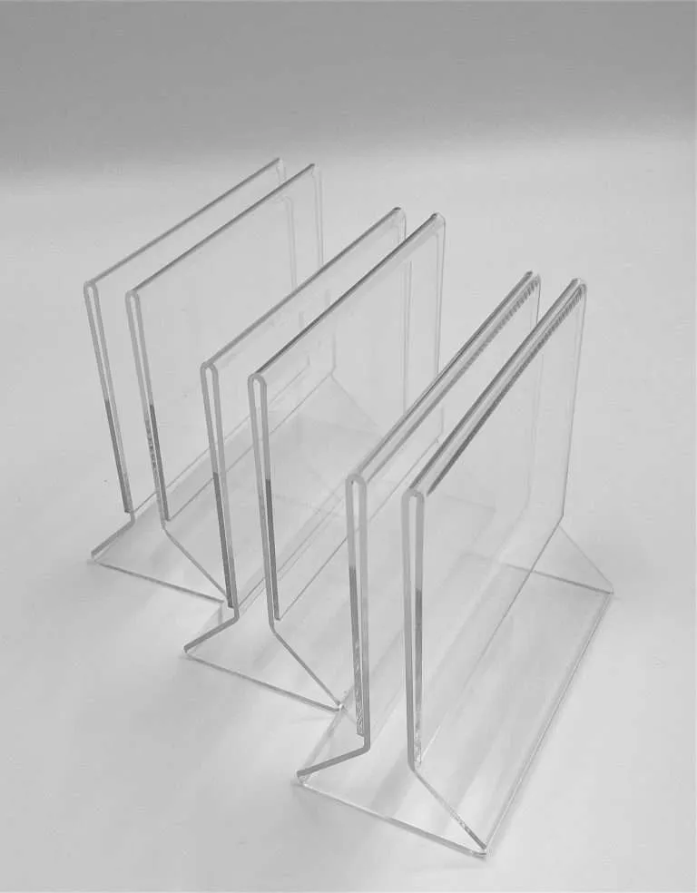 Row of clear acrylic T-base sign holders from a large-volume production run.