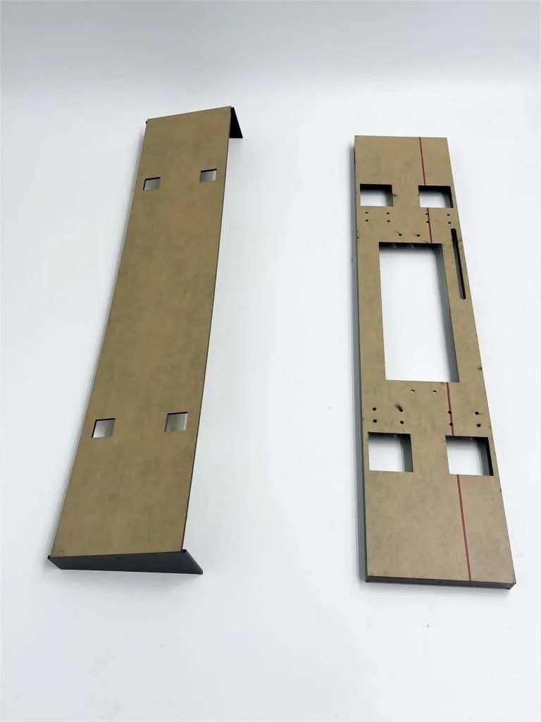 Two CNC-routed composite panels with machined cutouts and mounting holes.