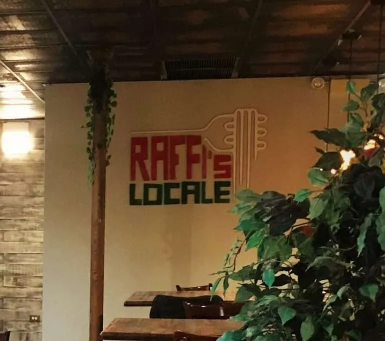 Laser-cut color acrylic restaurant logo sign mounted on a dining room wall