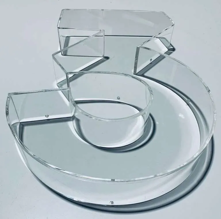 Oven-formed clear acrylic display shaped into a numeral with a bonded riser.