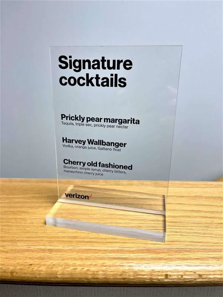Clear acrylic tabletop sign with a UV-printed cocktail menu